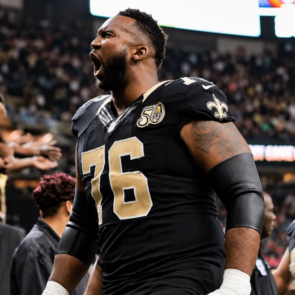 Tony Hills in a Saints uniform, number 76, celebrating on the field.